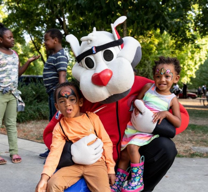 Blaze the "Trail Cat" with face painted kids.