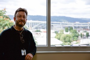Paul Bubl standing in front of classroom window