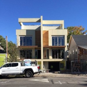 Picture of a cream and wood building with a white truck parked in front